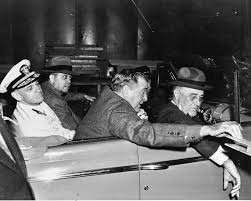 "President Franklin D Roosevelt with officials in New Orleans during World War II visit to Higgins Industries factory.