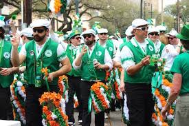 People in green attire celebrating St. Patrick’s Day parade in New Orleans highlighting Irish heritage and traditions