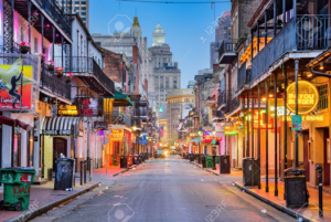 Bourbon Street in New Orleans French Quarter with colorful buildings balconies and nightlife atmosphere in historic city center