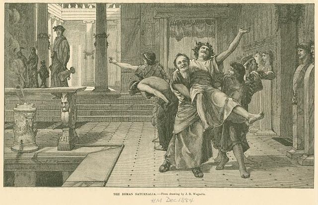 In John Reinhard Weguelin’s “The Roman Saturnalia,” a drunken reveler is carried away by his friends during the Saturnalia.