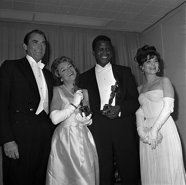 Gregory Peck, Annabella, Sidney Poitier and Anne Bancroft backstage at the Academy Awards, Los Angeles on April 14, 1964.