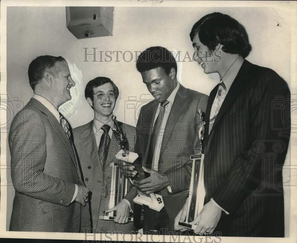 Former Tulane basketball coach Ralph Pederson (left), stands with three seniors awarded postseason honors. They are (from left) Mike Henry, honorary captain, Harold Sylvester, most valuable, and John Sutter, best rebounder. Photo was taken March 5, 1971.