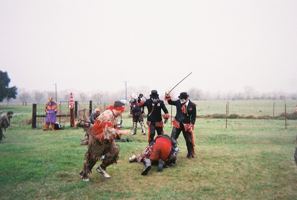 Participants of the 2013 Faquetaigue Courir de Mardi Gras fighting with the villains.