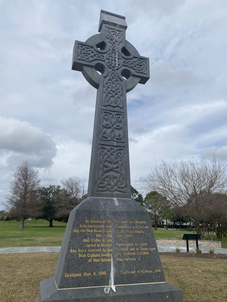 This large Kilkenny marble Celtric cross in New Basin Canal Park commemorates the Irish workers who built the canal that once flowed here. Thousands died during the project.
