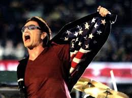 During the XXXVI halftime show, U2 lead singer Bono revealed an American flag embroidered into his jacket. The game was played just months after the 9/11 attacks and had a patriotic tone.