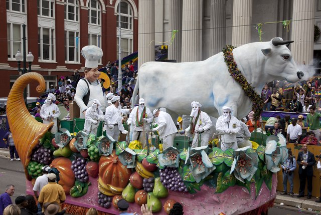 The Boeuf Gras rolls down Canal Street in New Orleans during the Rex parade in 2011. The “fatted ox” is surrounded by krewe members dressed as butchers and bakers. Photo credit to Carol M. Highsmith's America, Library of Congress, Prints and Photographs Division.